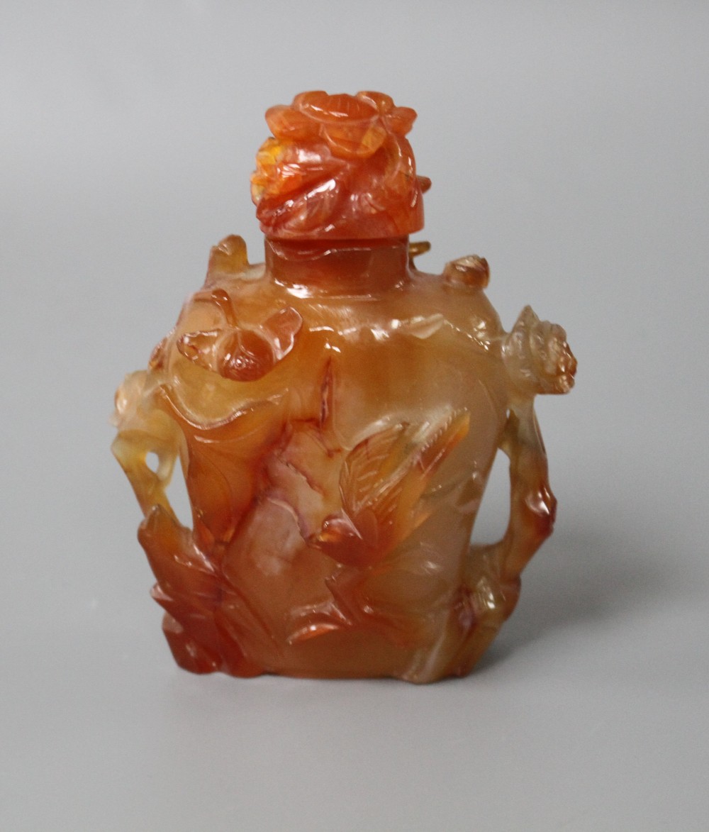 A Chinese orange agate snuff bottle and stopper, carved in relief with birds and flowers, width 6cm, height 8.5cm
